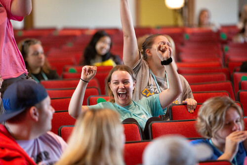a student cheering at the camp redhawk closing ceremony.