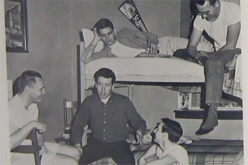 young men from an earlier decade sitting around in a dorm room and talking