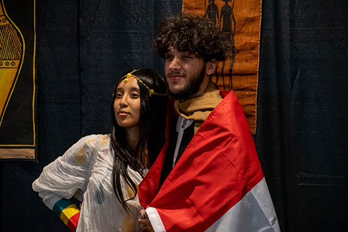 two students pose for a photo wearing african dress