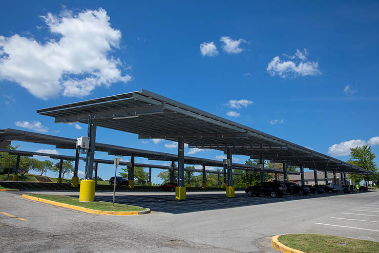 a wide view of the solar panels in the show me center parking lot under a very bright blue sky