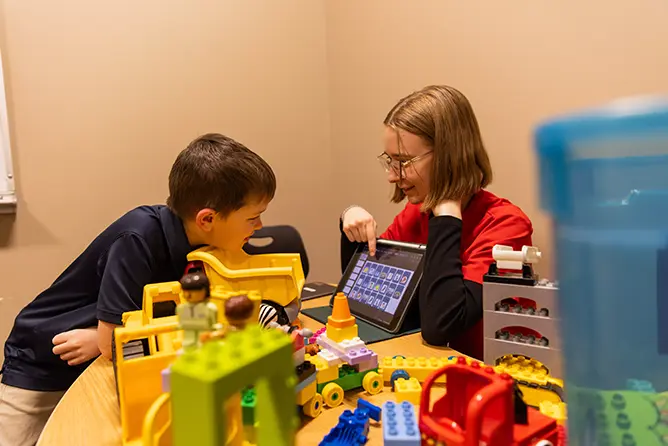 A SEMO student, majoring in speech language pathology, works with a child, getting clinic hours, at the Center for Speech and Hearing.
