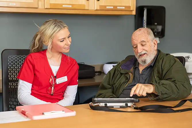 A SEMO student, majoring in communication sciences and disorders, works with an elderly patient, earning clinic hours at the Center for Speech and Hearing. 