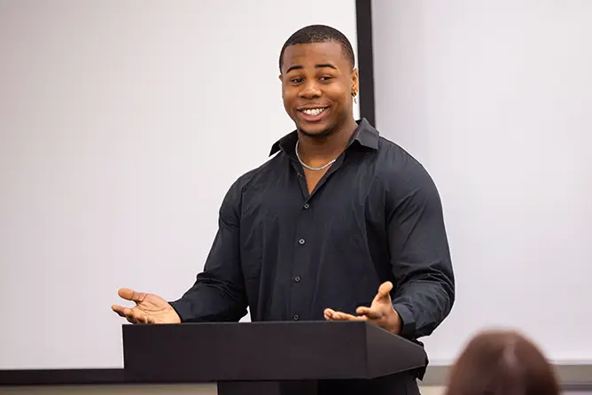 A student gives a presentation to his marketing class in Dempster. 