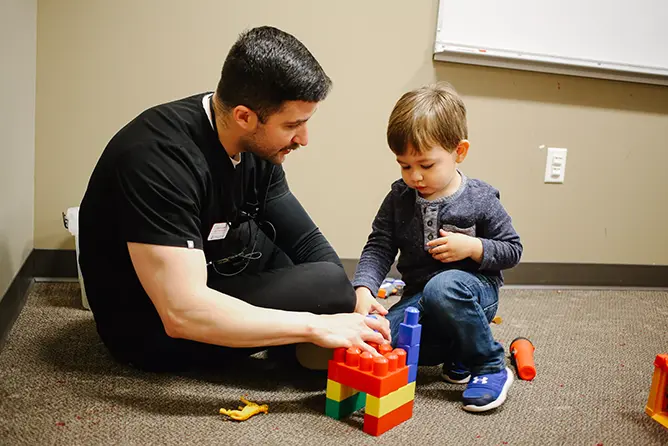 A speech language pathology student works with a child in the Center for Speech and Hearing.