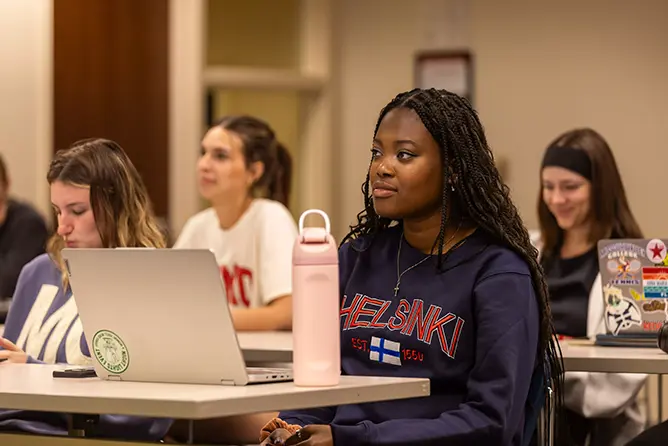 Students at their desks in the management program at SEMO enjoying class. 