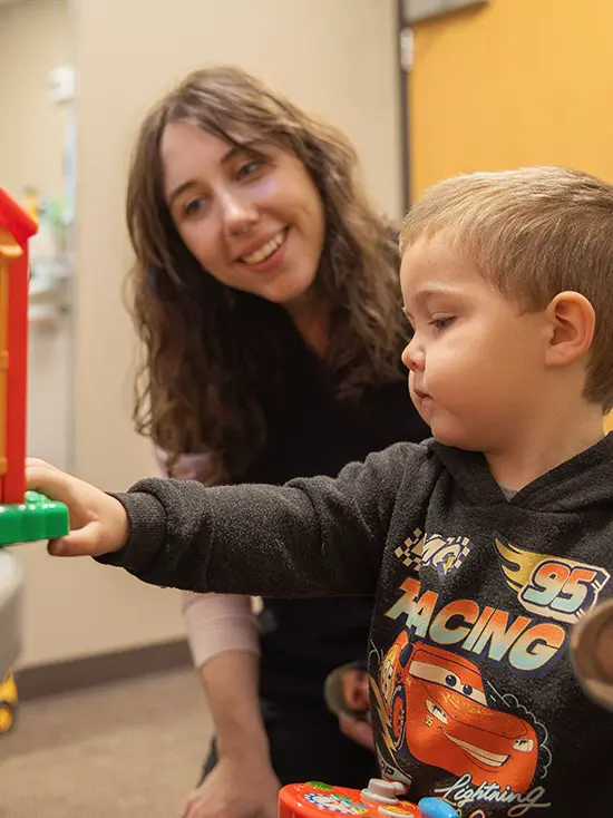 A communication disorders major works with a child in the speech and hearing clinic for clinical hours. 