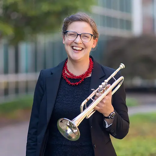 Dr. Deborah Caldwell smiles for her University headshot holding her trumpet at Southeast Missouri State University, a top-rated university for music in Missouri. 