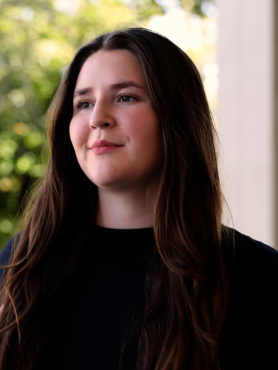 a professional portrait of emilie torres posed against a blurred out background