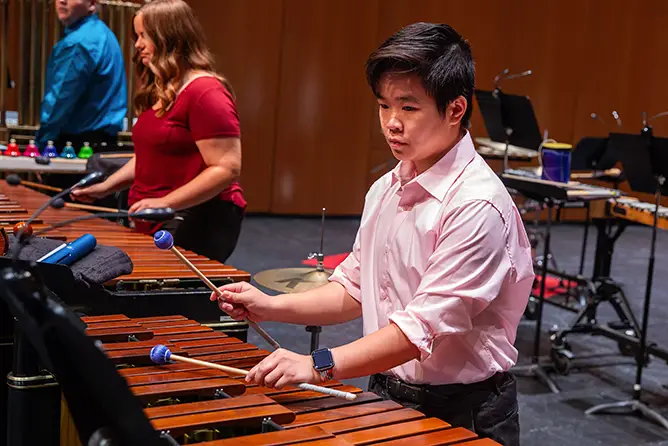  A student plays the xylophone in a percussion ensemble performance at SEMO, a top-rated music school in Missouri. 