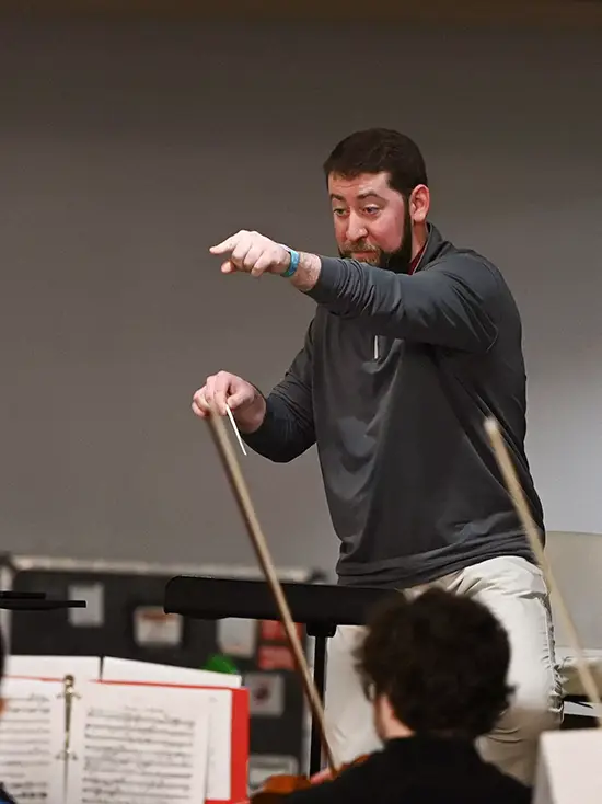 Patrick Hopkins, a music professor, conducts an orchestra class at Southeast Missouri State University, a top music school in Missouri. 