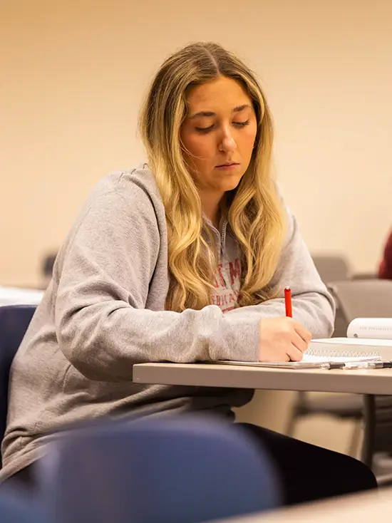 SEMO student takes notes in her class that is a part of an accredited marketing program in Missouri.  