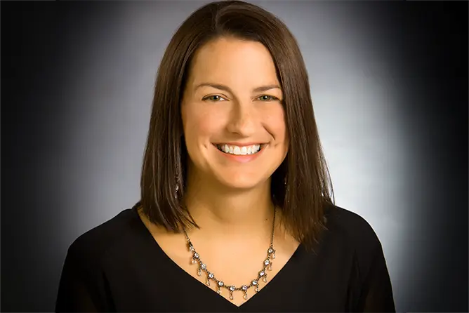 Mandy Keys, an employer who has hired speech language pathology students, smiles at the camera for her professional headshot.