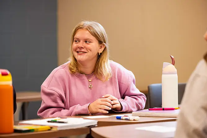 A female student in a social work class working on an activity