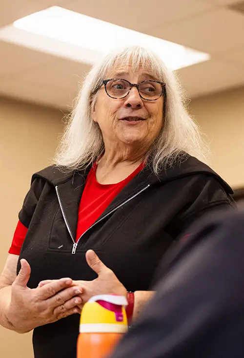 Kathie Miller, Bachelor of Social Work program director, talks with a student during class