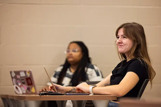 A social work student smiling in a social work class 