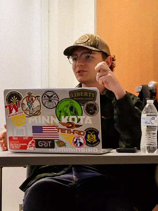 Will, a student, is participating in a bs political science class with his laptop out. 