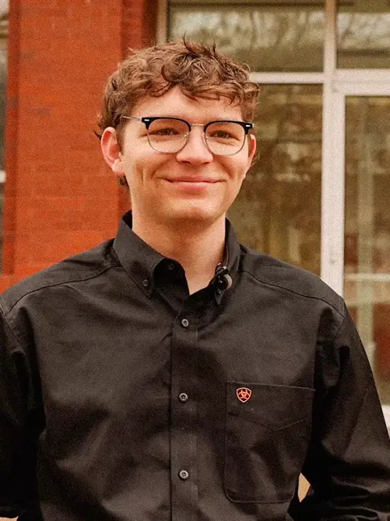 Will, a student in the bs political science program at SEMO, smiles in front of Carnahan Hall. 