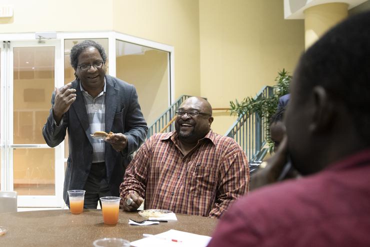 A Southeast professor stands at the front of the classroom and instructs his students.  