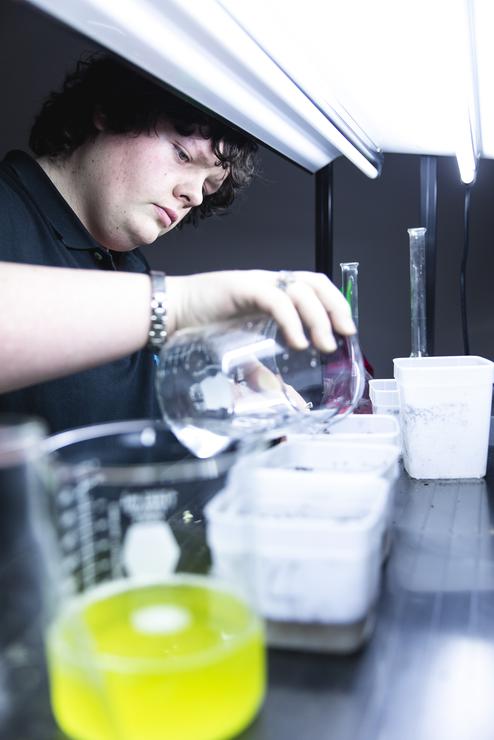 An agribusiness student waters test plants in the agriculture lab at the Kennett Regional Campus.