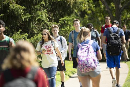Students walking along a campus sidewalk at Southeast Missouri State University on their way to class.