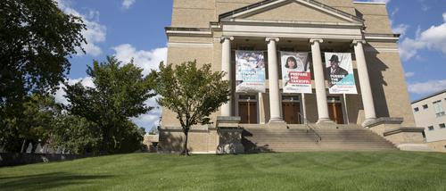 The front exterior of the Wehking Alumni Center displaying banners that feature alumni.