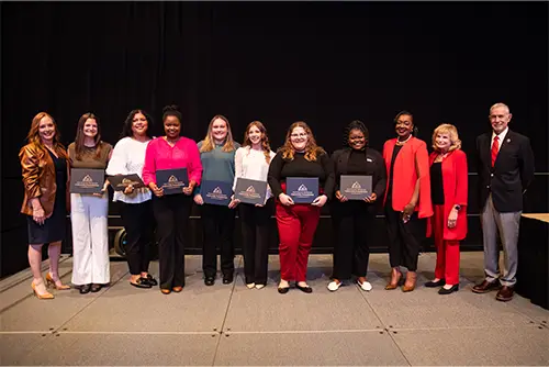 Two people sitting together at the annual Power of Women conference