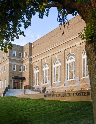 building with fountain and trees around it
