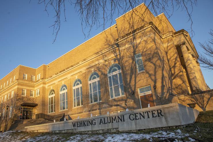 Sun shines on the exterior of the Wehking Alumni Center.