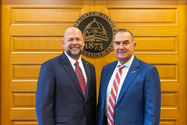 a SEMO employee shakes hand with Roy Blunt on the steps of Academic Hall on SEMO's campus