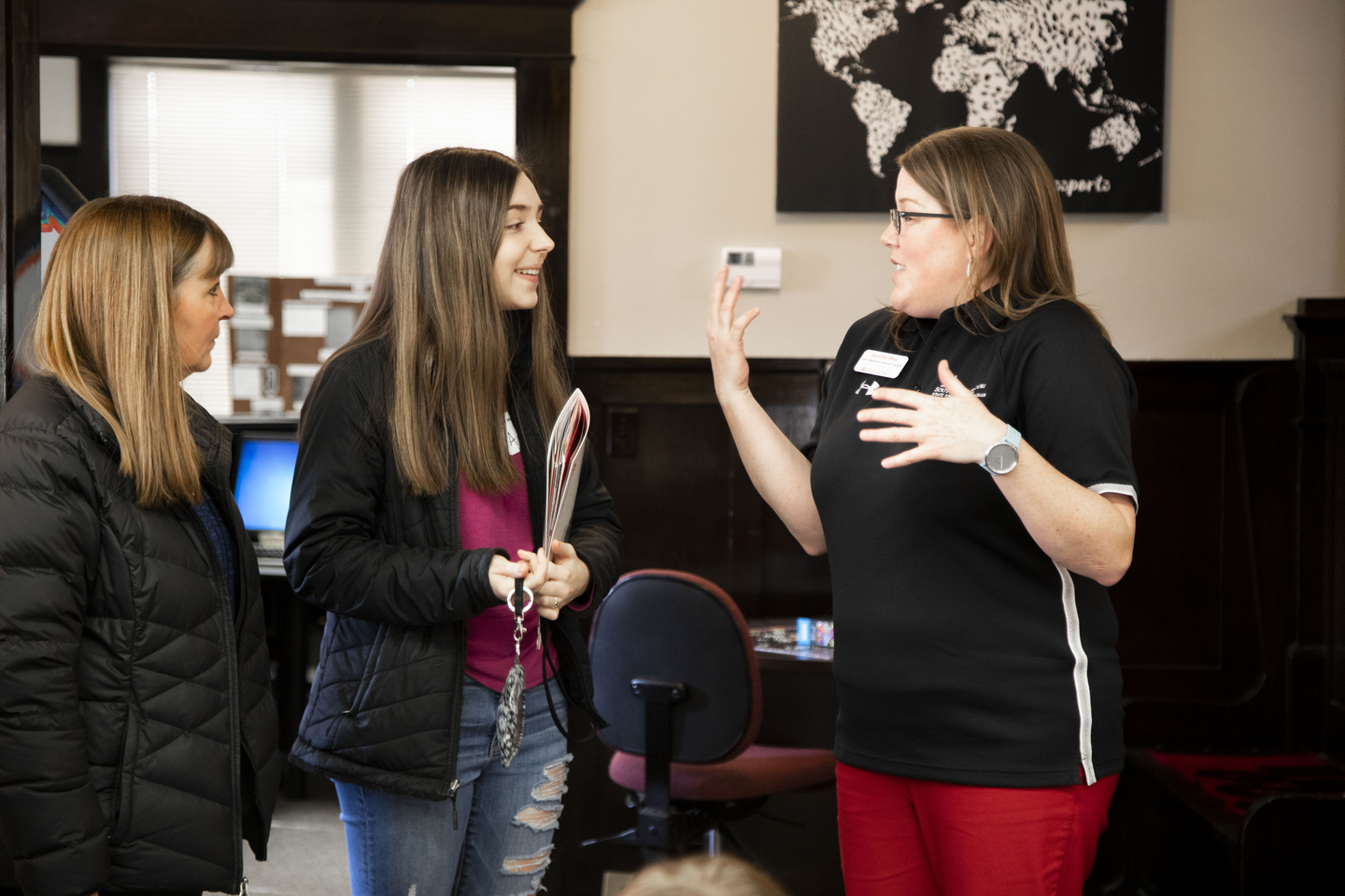 A student shows people around the Honors House during a Show Me Day event.