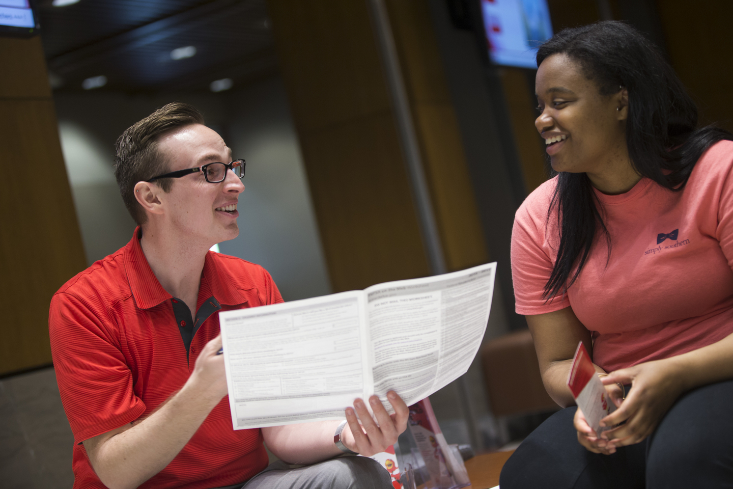 A Student Financial Services staff member talks with a student.