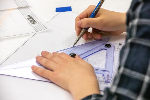 close up of interior design student in school at SEMO in cape girardeau mo, drafting during their final end of year project.