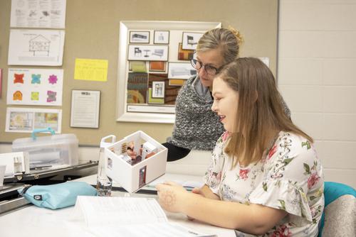 SEMO interior design student shows model she created for a local men's shelter in cape girardeau mo.
