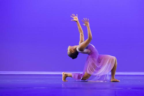 Dancer strike poses while on stage at the River Campus.