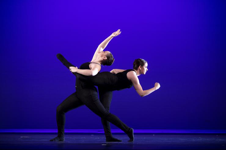 Two BA dancers pose on stage in Bedell Performance Hall.
