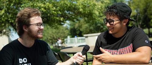 a student in the missouri mass communication program at semo for the Arrow interviews another Southeast student on campus. 