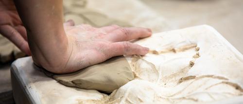 a close up shot of a bfa in art student crafting art using ceramics at Southeast Missouri State University. 