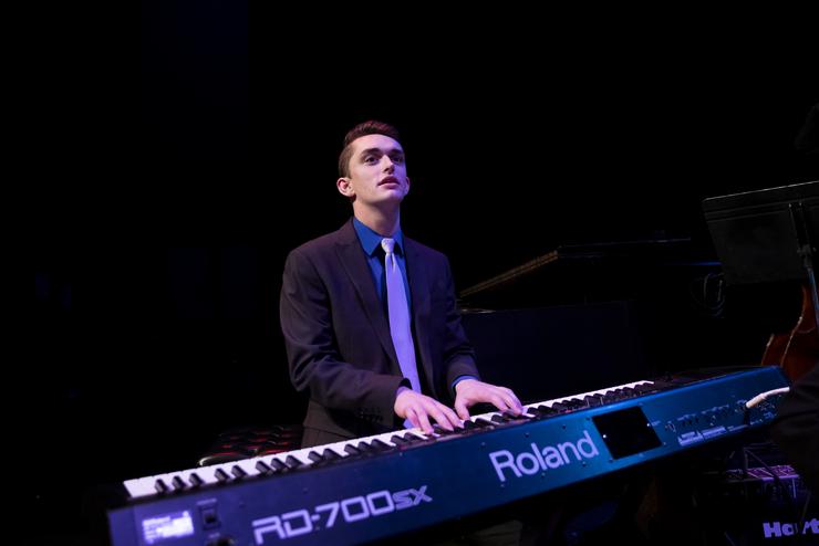A Music student plays the keyboard.