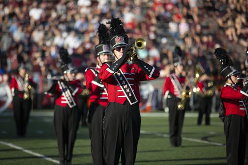 Marching Band members perform on the football field at Houck Stadium. 