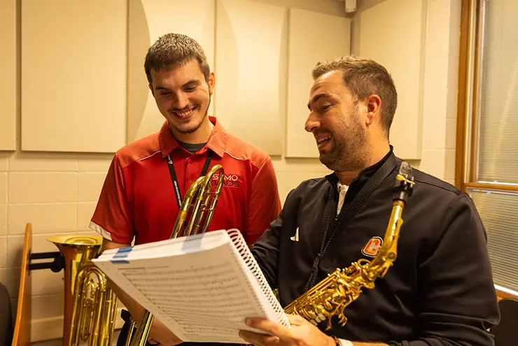 a SEMO music major goes over a page of music with his instructor