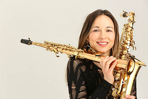 an artist invited as a guest to SEMO's music program poses for a professional headshot holding her instruments