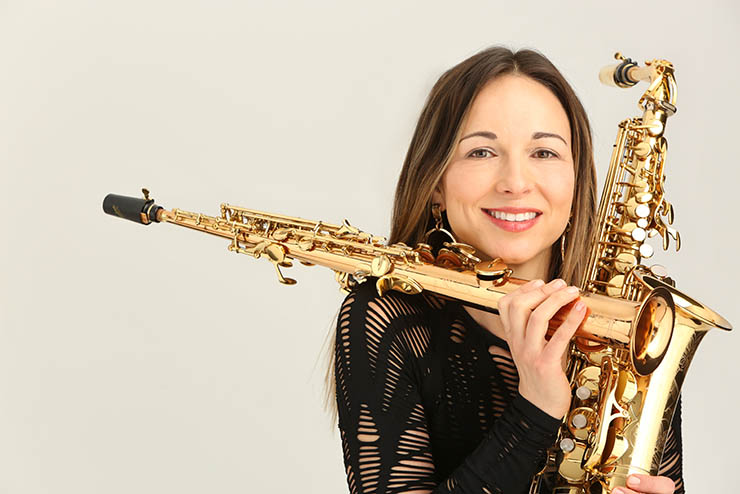 an artist invited as a guest to SEMO's music program poses for a professional headshot holding her instruments