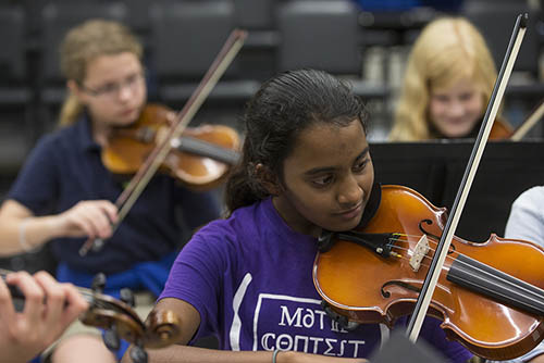 a music major student participates in a class with her violin