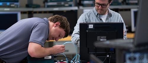 engineering technology computer network and management students rewire a hard drive at Seabaugh Polytechnic. 