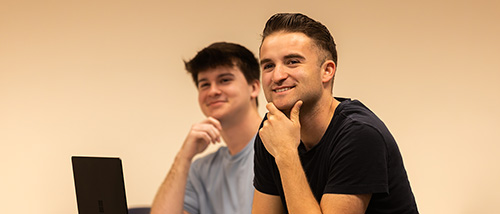 A sales and marketing student smiles during class.