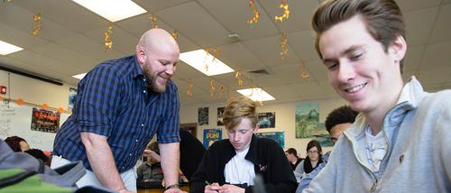 science elementary education majors working with a students in a classroom