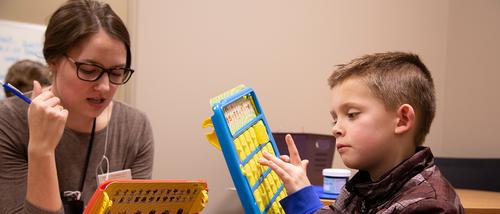 Communications disorder masters student working with child at the Center for Speech and Hearing 