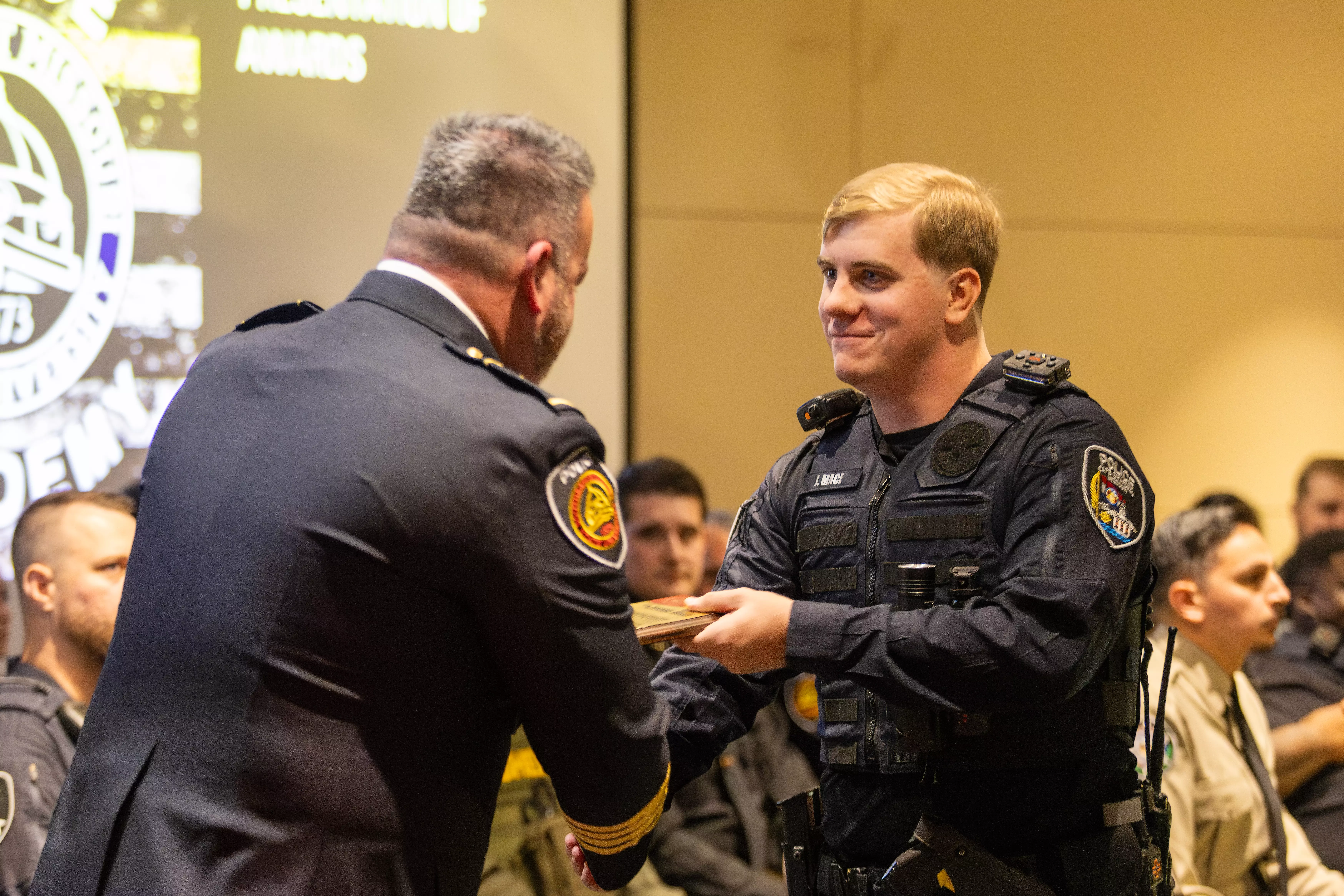 SEMO law enforcement academy graduate shaking hands with instructor at graduation ceremony