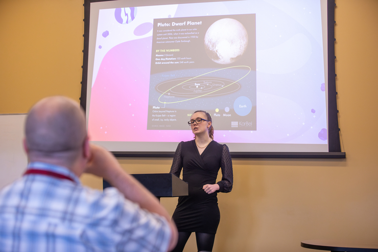 A student gives a presentation over Pluto, the dwarf planet.