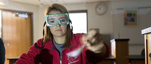 A Southeast Missouri State University physics student weighs ingredients for a test.